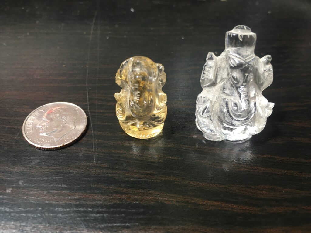 2 miniature ganesh murtis and 10¢
